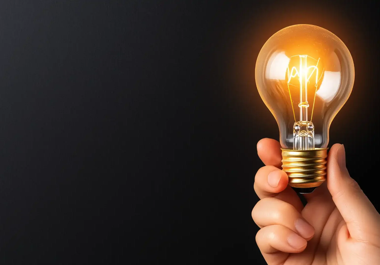 What is lighting design - hand holding a light bulb